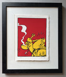 Framed artwork of a yellow character with a red background