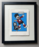 Dennis the menace from the beano and his dog gnasher are laughing at something and hold their stomachs in hilarity; he is dressed in a red and black striped football kit. In a black frame
