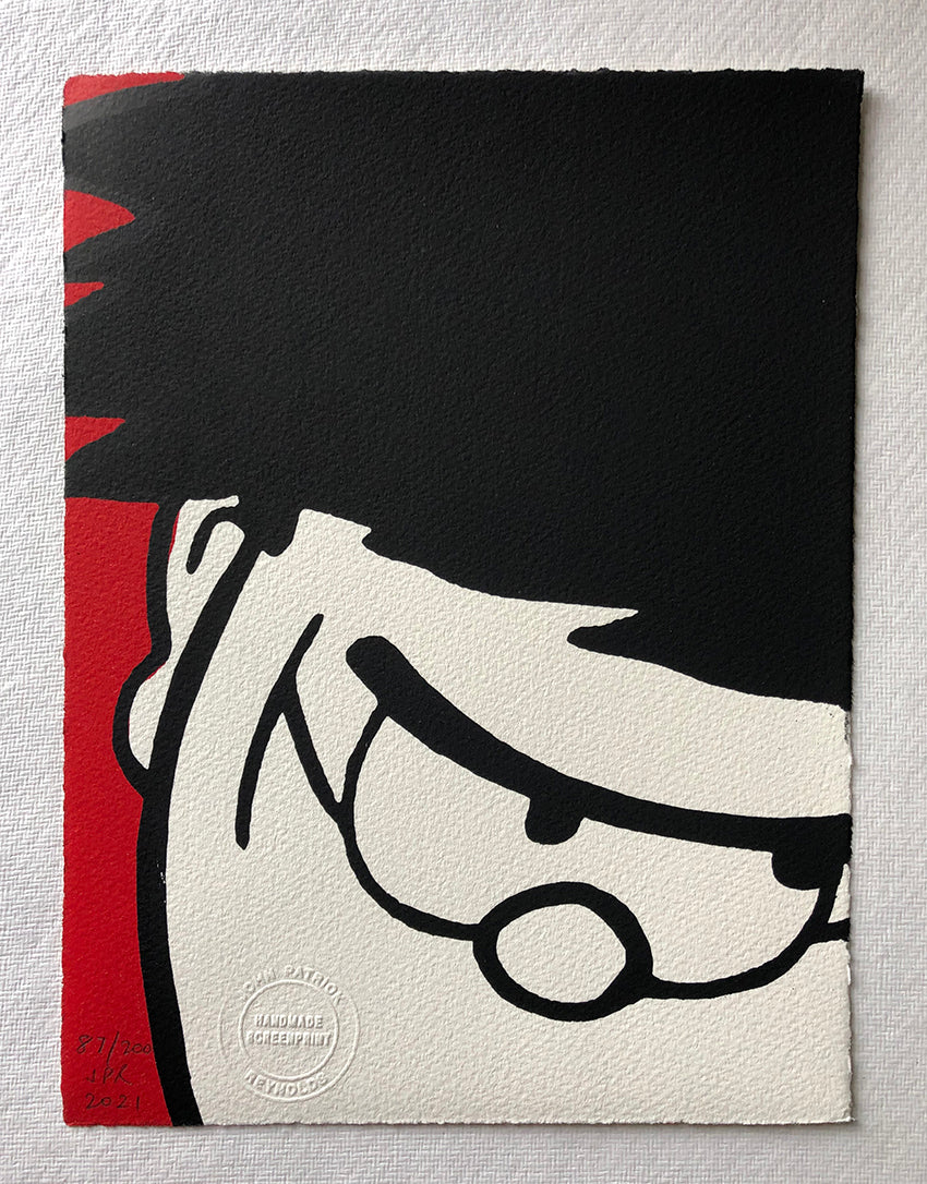 Dennis menace cracks a sly grin, in closeup. With a red background. From the beano comic