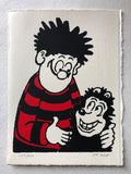 A smiling Dennis the menace wears his red and black jersey and hugs Gnasher. From the Beano comic. 
