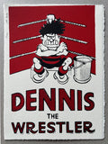 Dennis the menace, in his football strip, sits in the corner of a boxing ring, with his arms crossed, glowering
