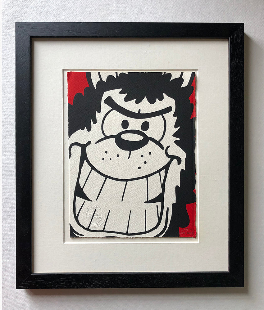 Gnasher the dog grins manically at the reader with a red background. From the beano comic