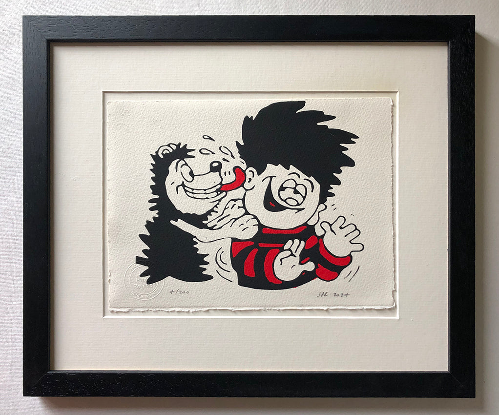 Gnasher lavishes affection on Dennis the menace by licking him. From the beano comic