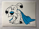 Dogmatix from the Asterix series looks sad underneath a blue blanket