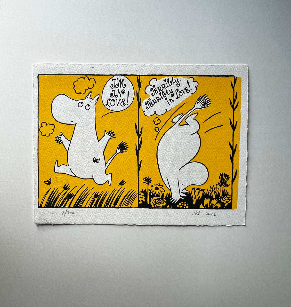 An art print featuring a two-panel cartoon illustration of Tove Jansson's Moomintroll doing somersaults on a yellow background