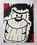 Gnasher the dog grins manically at the reader with a red background. From the beano comic
